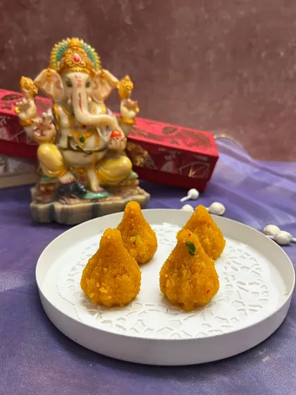 These are my classic motichoor laddoos, shaped into modaks for the festive season. A traditional favorite that everyone loves.