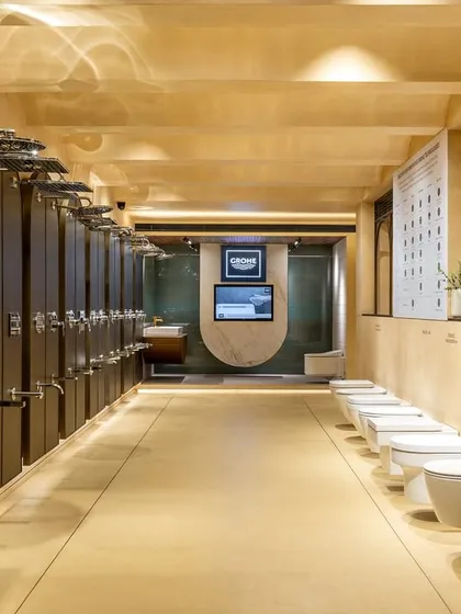 This long-view of the showroom demonstrates how I organize product displays for clarity and impact. The linear arrangement of showerheads and toilets allows for easy comparison, guided by clean sightlines and uniform lighting.
