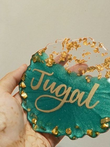 The light shining through this name plaque highlights the transparency of the resin and the floating gold pieces.