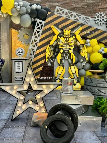 The Bumblebee section of the party, with a large character cutout, marquee star, and props like tires and a gas pump.