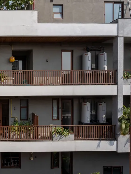 Even the functional elements of a building can contribute to its climate responsiveness. The open design of these balconies with simple wooden railings encourages cross-ventilation through the apartments.