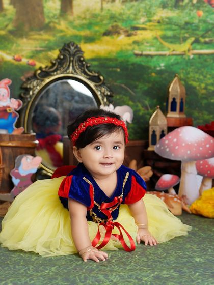 Our little Snow White crawling through the enchanted forest. This shot captures a moment of playful exploration during her fairytale-themed photoshoot.