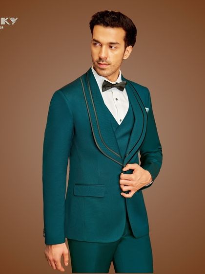 Make a statement of timeless elegance with our impeccably tailored teal tuxedo. The unique shawl collar design adds a touch of modern sophistication for your grand reception or stylish soirée.