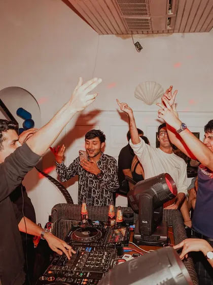 It's not just a solo act. This photo shows the energy of my friends and the crowd right there with me in the DJ booth.