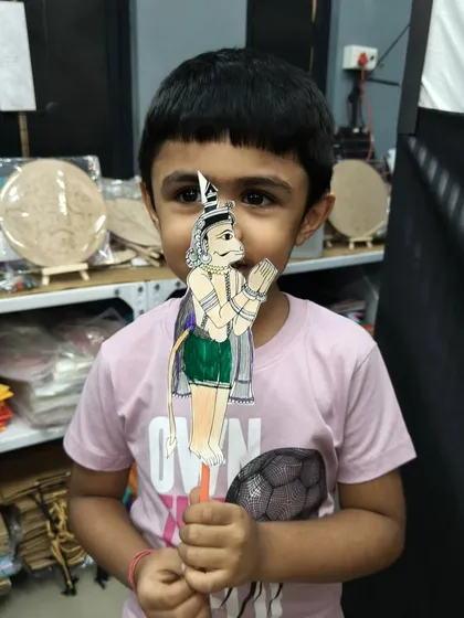 After the show, the kids get to make their own puppets. This young boy is proudly holding up his Hanuman puppet, a tangible memory of his introduction to the world of Indian folk art and storytelling.