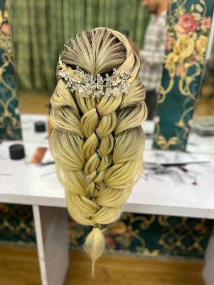 A finished look of a complex braid with a crystal accessory, showing the beautiful texture and volume.