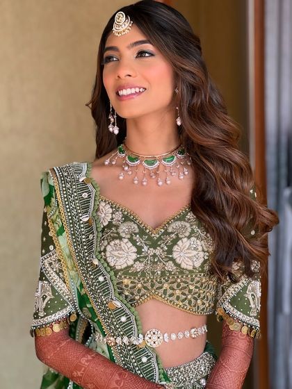 This modern bride's look is all about effortless elegance. The soft waves and natural makeup create a look that is both chic and timeless.