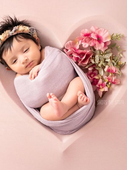 Another angle of this older newborn in the heart bowl, showing how we can adapt poses for babies who are a little more alert.