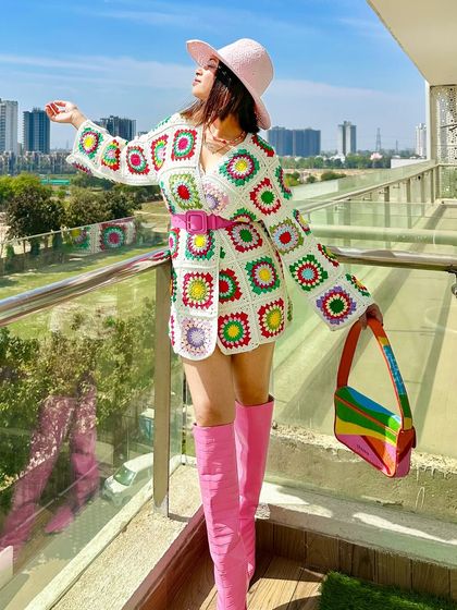 Who says you can't wear a summer hat in the winter? I styled this colorful crochet cardigan as a dress with bright pink boots and a matching hat for a fun, dopamine-filled spring look.