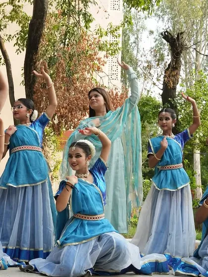 Here I am with a group of my students in their performance costumes. Seeing them ready to go on stage, filled with excitement and dedication, is a moment of great pride for me as their guru.