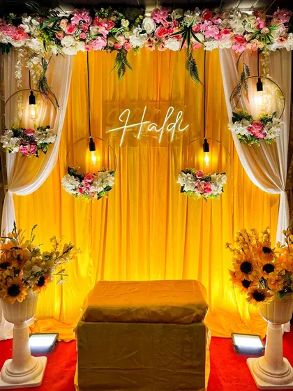 Here is a classic Haldi ceremony decor I created. The vibrant yellow backdrop, floral arrangements with sunflowers, and a custom neon "Haldi" sign create the perfect festive atmosphere for photos and rituals. This setup can be customized for any space, big or small.