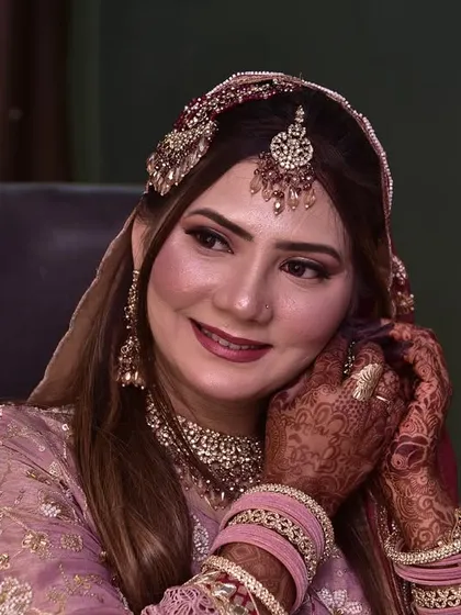 The bride adjusting her earring, with a beautiful smile. These are the happy moments I love to capture.