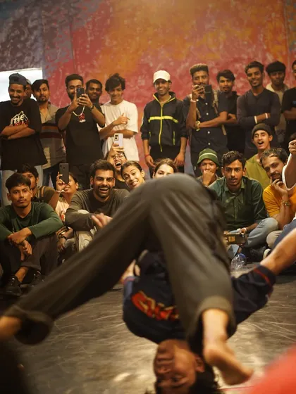 A view from behind the dancer, showing the crowd's reaction to a power move. The connection between the performer and the audience is what makes a live jam special.