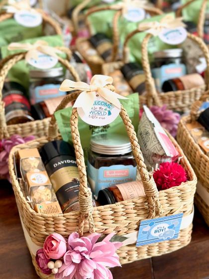 Another angle of the baby announcement hampers, showing the "Welcome to the world little one" tag.