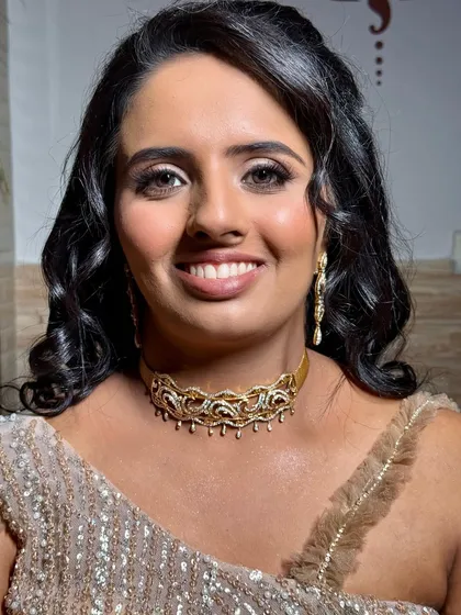 A close-up of the soft glam sangeet look. The makeup is subtle yet effective, with a touch of sparkle on the eyes and a beautiful nude lip.