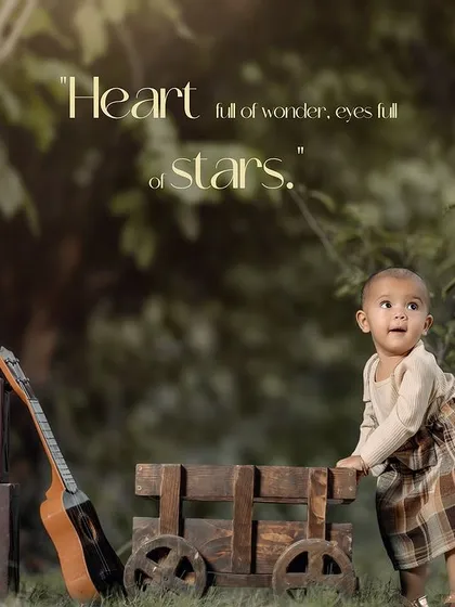 A beautiful outdoor first birthday portrait with a rustic wooden cart and guitar, capturing a moment of quiet curiosity.