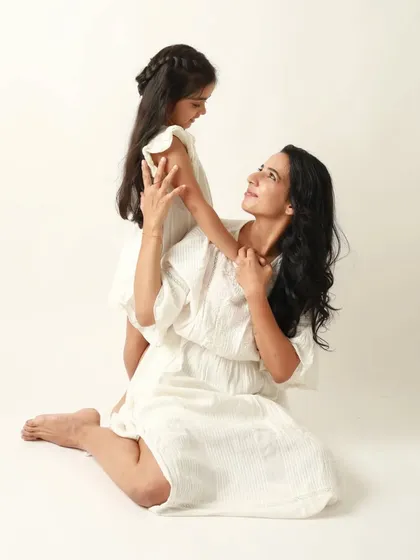 A beautiful, classic portrait of a mother and her daughter, sharing a look of deep connection and understanding.