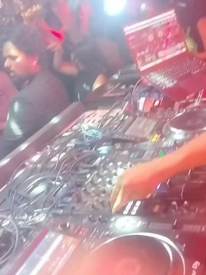 A close-up of my hands on the mixer at Social Koramangala. This is where the magic happens, blending tracks and creating the perfect flow for the dance floor.