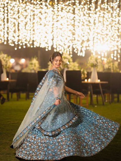 A twirling shot that captures the magnificent flare of the lehenga under the enchanting lights. Movement adds life to any outfit.