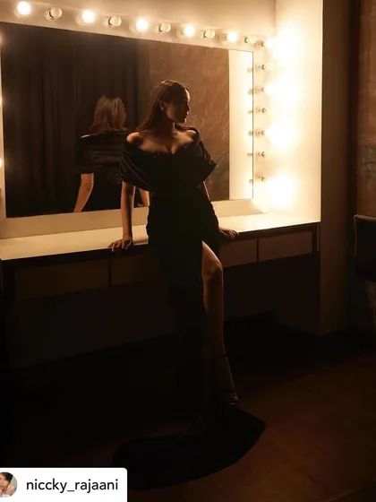 A behind-the-scenes moment in the vanity room. This atmospheric shot captures the mood of getting ready for a big event, with makeup that is both striking and elegant.