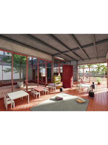 A classroom interior at The Atelier, where full-height glass walls open onto a central courtyard. This brings natural light, ventilation, and a view of nature directly into the learning environment, creating a calm and stimulating atmosphere.