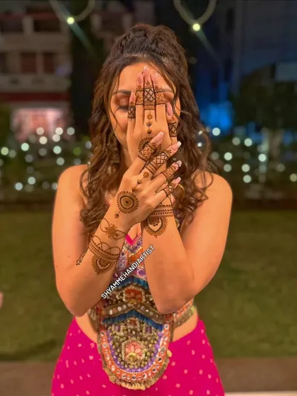 This is how my henna art looks on a happy client. I focus on creating designs that are not only beautiful up close but also complement your overall look for any occasion.