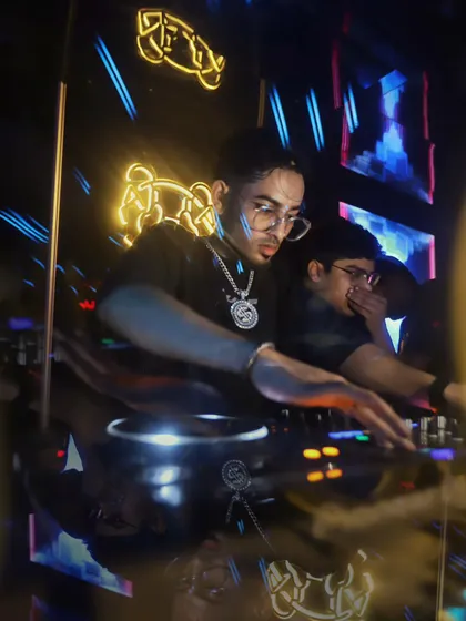 A prism effect shot of me focused on the DJ controller. This captures the dynamic and visually stimulating environment of my club nights.