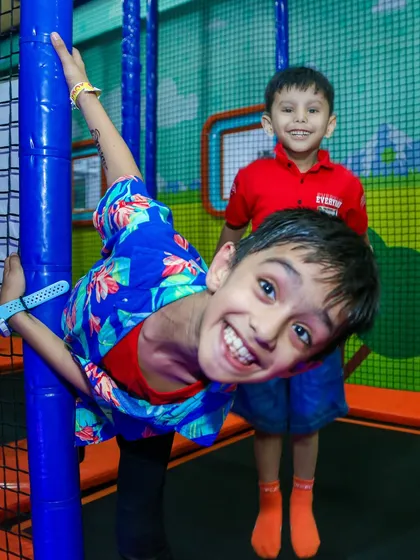 Hanging around and having fun on the padded poles of our trampoline park. The entire area is designed for safe and creative play.