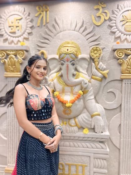 Another angle of this fun and festive Garba look. The high ponytail keeps the hair off the face for dancing, while the subtle makeup highlights her natural features beautifully.