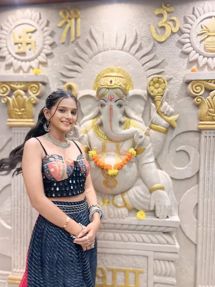 Another angle of this fun and festive Garba look. The high ponytail keeps the hair off the face for dancing, while the subtle makeup highlights her natural features beautifully.