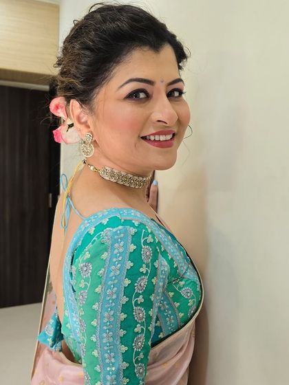 A happy, side profile showing the beautiful hairstyle adorned with fresh roses. It adds a touch of romance to the elegant look.