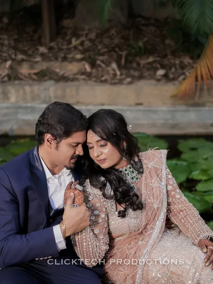 An intimate close-up of the couple sharing a quiet moment by a lily pond.