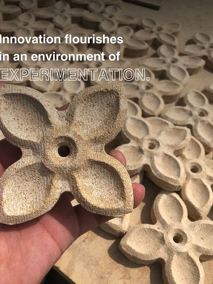 Innovation flourishes in an environment of experimentation. This close-up shows handcrafted floral motifs made from a stone-resin composite, a result of our fearless exploration of new materials and techniques.