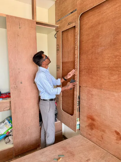 Checking the dimensions and cutouts for a wardrobe unit during its assembly.
