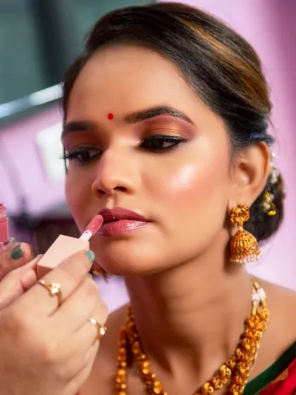 The art of makeup in progress. Here I am applying a soft nude lipstick to complete this dreamy, glowing look.