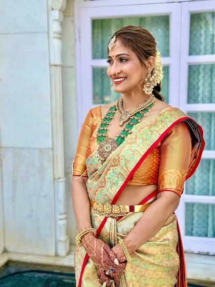 A beautiful smiling portrait taken outdoors. The natural light enhances the radiant quality of her skin, a key element of my bridal makeup style.