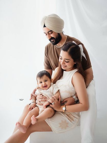 A classic family pose, with everyone smiling for the camera. A perfect keepsake.