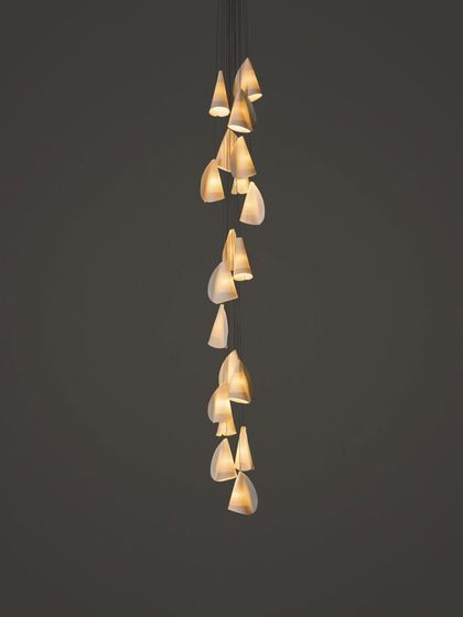 A long, cascading installation of the Bocci 21 series, its form elegantly spiraling downwards.