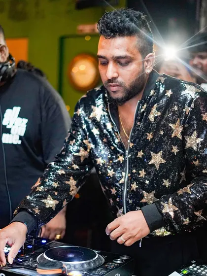 In the zone, focused on the mix. This is me at a club gig, curating the sound and telling a story with every track I play on the Pioneer decks.