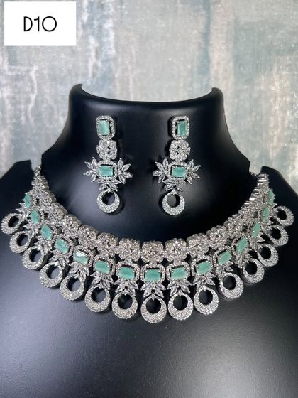 A clear view of the mint green and silver diamond choker set. The matching earrings complete the look, offering a fresh and modern take on party wear jewellery.