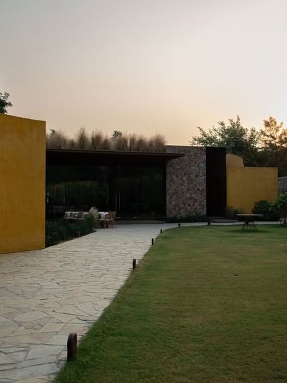 The property at twilight, where the fading light softens the architectural lines and the garden begins to glow.