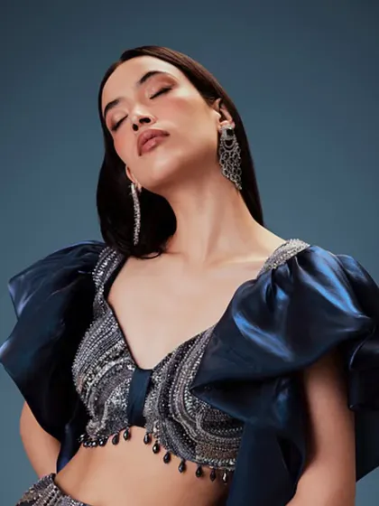 A close-up of a glamorous makeup look for Kalki Fashion. I used soft, shimmery eyeshadow and a glossy nude lip, paired with sleek hair to complement the heavily embellished blue top.