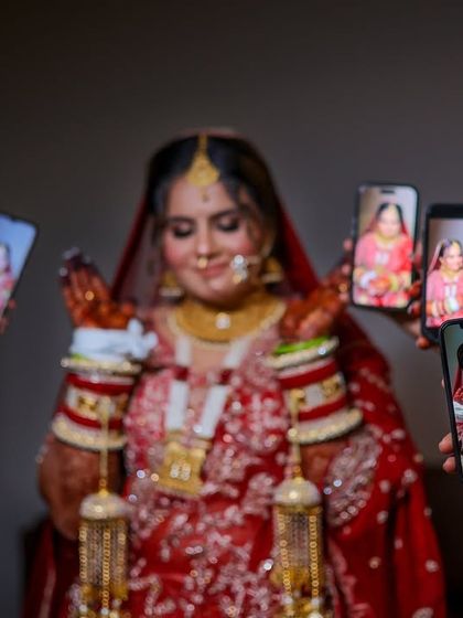 A fun and modern shot, with friends holding up their phones to show their pictures of the bride.