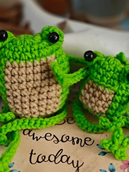 A pair of cheerful green frogs to brighten your day. These little amigurumi friends, with their big eyes and friendly smiles, are perfect as desk buddies or a cute gift to remind someone to be awesome.