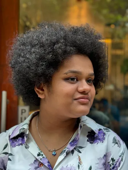 Here is a client embracing her beautiful, voluminous natural afro before her styling session. I always start by assessing the hair's unique texture and density to determine the best approach for its health and the client's goals.