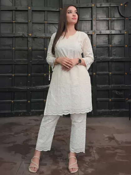 An all-white Chikankari kurta and pant set. This showcases the beauty of traditional Lucknowi embroidery in a clean, modern silhouette that is both elegant and understated.