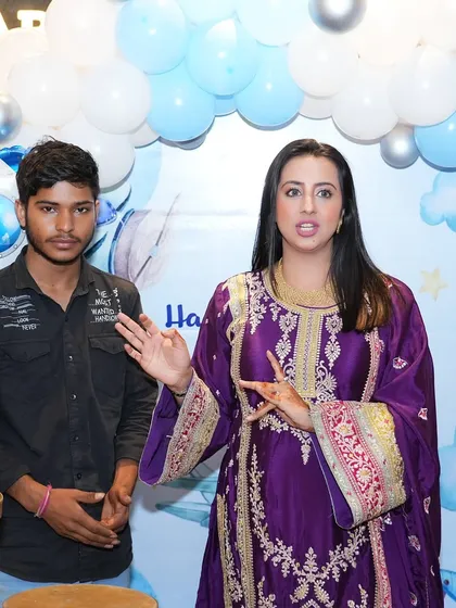 Actress Sanjjanaa Galrani speaking during her son's birthday party, with our blue and white balloon backdrop behind her. It's always a pleasure to work with such wonderful clients.