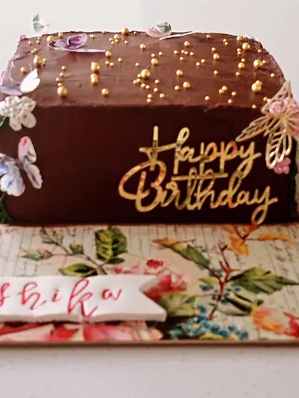 An overloaded dark chocolate loaf cake with a beautiful garden theme. I used edible butterflies and a gold "Happy Birthday" topper to create a whimsical and delicious celebration cake.