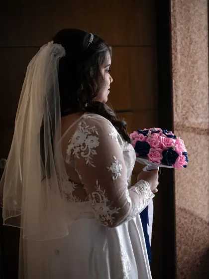 A pensive bridal portrait, using shadows and light to create a moody and artistic image. It's a quiet moment of reflection before the ceremony.