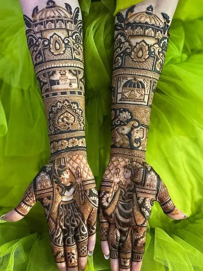 This design features bold, dark-stained figures and motifs, including elephants and a kalash, against a vibrant green background.